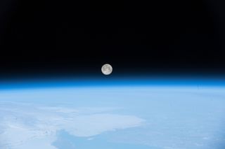 Full Moon rising above atmosphere