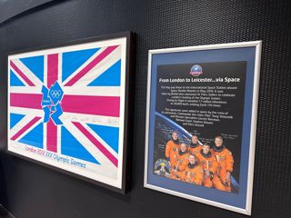 The 2012 Olympic flag signed by astronauts on display outside the Planetarium.